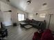 Spacious living room with L-shaped sofa and tile flooring at 22005 W Cocopah St, Buckeye, AZ 85326