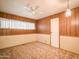 Bedroom with wood paneled walls and ceiling fan at 120 N Val Vista Dr # 264, Mesa, AZ 85213