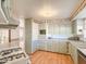 Bright kitchen features light green cabinets and wood flooring at 120 N Val Vista Dr # 264, Mesa, AZ 85213
