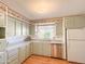 Kitchen features light green cabinets, stainless steel appliances, and wood flooring at 120 N Val Vista Dr # 264, Mesa, AZ 85213