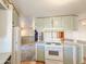 Kitchen with island, light green cabinets, and a white stove at 120 N Val Vista Dr # 264, Mesa, AZ 85213