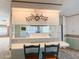 Kitchen breakfast bar with two chairs and decorative clock at 120 N Val Vista Dr # 264, Mesa, AZ 85213