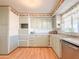 Galley-style kitchen with light green cabinets and stainless steel appliances at 120 N Val Vista Dr # 264, Mesa, AZ 85213