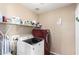 Bright laundry room with washer and dryer, and storage shelves at 745 E Megan St, Chandler, AZ 85225