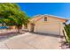 Front view of house with desert landscaping, tree, and driveway at 745 E Megan St, Chandler, AZ 85225
