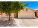 Front view of house with desert landscaping, tree, and driveway at 745 E Megan St, Chandler, AZ 85225