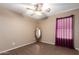 Well-lit bedroom with tile floors and a full-length mirror at 745 E Megan St, Chandler, AZ 85225