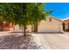 Front view of house with desert landscaping, tree, and driveway at 745 E Megan St, Chandler, AZ 85225