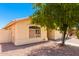 Front view of house with desert landscaping, tree, and driveway at 745 E Megan St, Chandler, AZ 85225