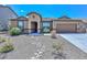 Tan house with a landscaped front yard and a rock pathway at 10773 W Swayback W Pass, Peoria, AZ 85383