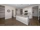 Kitchen features granite countertops, island, and white cabinets at 10773 W Swayback W Pass, Peoria, AZ 85383