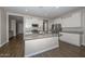 Spacious kitchen with granite countertops, stainless steel appliances, and an island at 10773 W Swayback W Pass, Peoria, AZ 85383