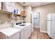 Laundry room with washer, dryer, and overhead shelving at 10773 W Swayback W Pass, Peoria, AZ 85383