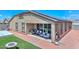 Home with covered patio, artificial turf, and solar panels at 10773 W Swayback W Pass, Peoria, AZ 85383