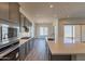 Modern kitchen with gray cabinets, quartz countertops and stainless steel appliances at 18938 W Ocotillo Rd, Waddell, AZ 85355