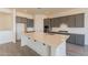 Modern kitchen with gray cabinets, quartz countertops, and stainless steel appliances at 18938 W Ocotillo Rd, Waddell, AZ 85355