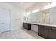 Elegant bathroom with double vanity, granite countertop and dark brown cabinets at 18950 W Ocotillo Rd, Waddell, AZ 85355