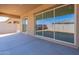 Covered patio with sliding glass doors and backyard access at 18950 W Ocotillo Rd, Waddell, AZ 85355