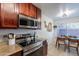 Eat-in kitchen with stainless steel appliances and wood cabinets at 3500 N Hayden Rd # 1005, Scottsdale, AZ 85251