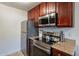 Kitchen with stainless steel appliances and wood cabinets at 3500 N Hayden Rd # 1005, Scottsdale, AZ 85251