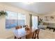 Open dining area with wood table and chairs, and living room view at 3500 N Hayden Rd # 1005, Scottsdale, AZ 85251