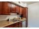 Kitchen with wood cabinets, granite counters, and stainless steel appliances at 3500 N Hayden Rd # 1005, Scottsdale, AZ 85251