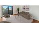 Living room with wood floors, featuring a comfy couch and access to a balcony at 4730 W Northern Ave # 3067, Glendale, AZ 85301
