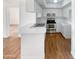 Bright eat-in kitchen, featuring white cabinetry, stainless steel appliances, and wood flooring at 4730 W Northern Ave # 3067, Glendale, AZ 85301