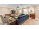Bright living room with comfy sectional sofa and wood-look tile floors at 8608 E Angus Dr, Scottsdale, AZ 85251