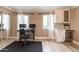 Home office with built-in cabinetry and hardwood floors at 8608 E Angus Dr, Scottsdale, AZ 85251