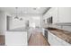 Spacious kitchen with white cabinets and granite island at 21451 W Palm Ln, Buckeye, AZ 85396