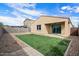 Artificial turf backyard with covered patio at 21451 W Palm Ln, Buckeye, AZ 85396