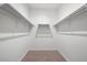 Large walk-in closet with double hanging rods and shelving at 21451 W Palm Ln, Buckeye, AZ 85396