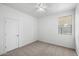 Simple bedroom with carpeted floor and ceiling fan at 21451 W Palm Ln, Buckeye, AZ 85396
