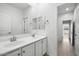 Clean bathroom with double vanity and access to hallway at 21451 W Palm Ln, Buckeye, AZ 85396