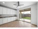 Bright kitchen with white cabinets, granite counters, and sliding door to backyard at 21451 W Palm Ln, Buckeye, AZ 85396