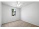 Simple bedroom with carpeted floor and window at 21451 W Palm Ln, Buckeye, AZ 85396