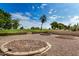 Landscaped backyard with circular gardens and golf course view at 9225 N 107Th Ave, Sun City, AZ 85351