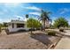 White single story home with landscaped yard and palm trees at 9225 N 107Th Ave, Sun City, AZ 85351