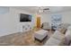 Living room with beige sofas, tiled floors, and a large TV at 2343 E Meadow Land Dr, San Tan Valley, AZ 85140