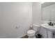 Clean bathroom with pedestal sink and tile floor at 2343 E Meadow Land Dr, San Tan Valley, AZ 85140