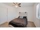 Cozy bedroom with a bed, nightstand and ceiling fan at 2343 E Meadow Land Dr, San Tan Valley, AZ 85140