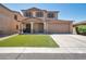 Two-story home with a brown garage door and green lawn at 2343 E Meadow Land Dr, San Tan Valley, AZ 85140