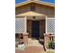 Brick home with a covered porch, lattice accents, and a well-maintained front yard at 303 N 7Th St, Avondale, AZ 85323