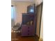 Bedroom featuring a purple cabinet, brown chair, and flat-screen TV at 303 N 7Th St, Avondale, AZ 85323