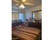 Main bedroom with striped bedding, dresser, and ceiling fan at 303 N 7Th St, Avondale, AZ 85323