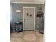 Inviting entryway with tile flooring, sunflower wreath, and coat rack at 303 N 7Th St, Avondale, AZ 85323