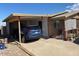 Ranch style home with carport, brick facade, and a spacious front yard at 303 N 7Th St, Avondale, AZ 85323