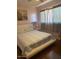 Bedroom with white platform bed, nightstand, and window curtains at 303 N 7Th St, Avondale, AZ 85323