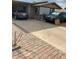 Brick ranch home with a covered carport and large driveway at 303 N 7Th St, Avondale, AZ 85323